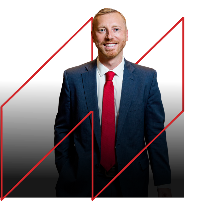Professional lawyer in a suit with a red tie, smiling against a black background, symbolizing trust and expertise in personal injury law.