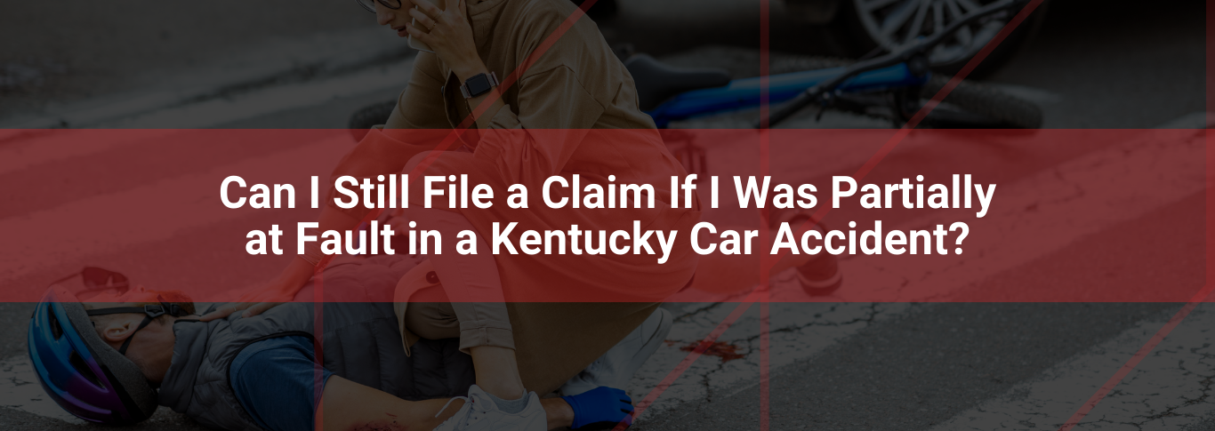 Injured cyclist receiving assistance on the road with overlay text asking about filing claims for partial fault in Kentucky car accidents.
